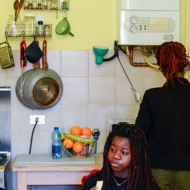 young black girl with afro dreadlocks hair style having breakfast at home with mother high res image